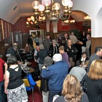 2/19/11 - 28th Annual Castagnetto / Spediacci Memorial Crab Feed - Italian American Social Club, San Francisco - Members and guests coming in and looking for family and friends. Center, in blue jacket, is Joe & Emily Farrah; sitting just past the jukebox is Bill Mayta.