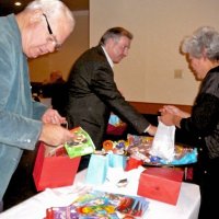 12/19/12 - Club Christmas Party at the Basque Clutural Center, South San Francisco - L to R: Bob Quinn, Bob Fenech, and Sandee Ige bagging gift bags for students at the upcoming “Christmas with Santa” at the Mission Educational Center on December 21st.