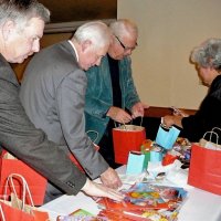 12/19/12 - Club Christmas Party at the Basque Clutural Center, South San Francisco - L to R: Bob Fenech, Ward Donnelly, Bob Quinn, and Sandee Ige bagging gift bags for students at the upcoming “Christmas with Santa” at the Mission Educational Center on December 21st.