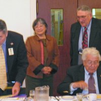 7/18/12 - Installation of Officers at the Italian American Social Club, San Francisco - PDG Eugene Chan, left, installing new member Margine Sako, standing center, while her sponsor, Handford Clews, left, looks on. Foe Farrah seated.