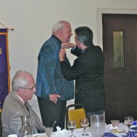 7/18/12 - Installation of Officers at the Italian American Social Club, San Francisco - PDG Eugene Chan pins Bob Quinn’s president’s pin on his lapel. Ward Donnelly, outgoing president, is seated.