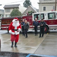 12-21-12 - Christmas with Santa at Mission Educational Center, San Francisco - Santa and is firefighter escort arrive.