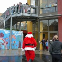 12-21-12 - Christmas with Santa at Mission Educational Center, San Francisco - Children look on as Santa arrives at their building.