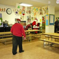 12-21-12 - Christmas with Santa at Mission Educational Center, San Francisco - Bob Lawhon, foreground, moving to greet Sant and his escort.