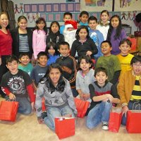 12-21-12 - Christmas with Santa at Mission Educational Center, San Francisco - A class poses with Santa after receiving their gift bags.