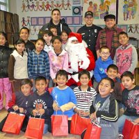 12-21-12 - Christmas with Santa at Mission Educational Center, San Francisco - A class poses with Santa after receiving their gift bags.