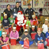 12-21-12 - Christmas with Santa at Mission Educational Center, San Francisco - A class poses with Santa after receiving their gift bags.