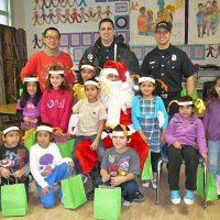 12-21-12 - Christmas with Santa at Mission Educational Center, San Francisco - A class poses with Santa after receiving their gift bags.