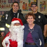 12-21-12 - Christmas with Santa at Mission Educational Center, San Francisco - Principal Deborah Molof posing with Santa and his helpers.