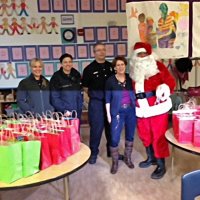 12-21-12 - Christmas with Santa at Mission Educational Center, San Francisco - Principal Deborah Molof posing with Santa and his helpers.