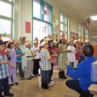 11-16-12 - Thanksgiving Luncheon, Mission Educational Center, San Francisco - Students sing while being led by a classmate and their teacher.