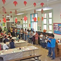 11-16-12 - Thanksgiving Luncheon, Mission Educational Center, San Francisco - Students playing a song on a recorder, accompanied by a single drum.