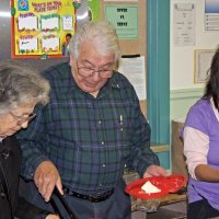 11-16-12 - Thanksgiving Luncheon, Mission Educational Center, San Francisco - Serving the turkey are Emily & Joe Farrah, while May Wong adds vegetables to the plate.