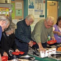 11-16-12 - Thanksgiving Luncheon, Mission Educational Center, San Francisco - In full swing serving lunch are, L to R, Aaron Straus, Emily & Joe Farrah, Bob Quinn, May Wong, and a cafeteria worker.