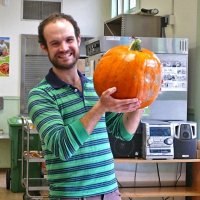 11-16-12 - Thanksgiving Luncheon, Mission Educational Center, San Francisco - A helper holds up the only pumpkin in the room.