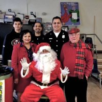 12-20-13 - Mission Educational Center, San Francisco - Zenaida & Bob Lawhon with Santa and other members of Los Bomberos de San Francisco.