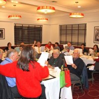 12-15-16 - Club Christmas Party, Basque Cultural Center, South San Francisco - Singing Christmas carols are, near table, near side, L to R: Ernie Brahn, Millie Gaw, Jackie & Gerald Lowe, Handford Clews, and Rosalinda Corvi; near table, far side: George & Kathy Salet, Bill Graziano, Joe Farr, and Al Gentile; far table, near side: Stephen Martin, Bob Lawhon, and Paul Corvi; far side: two giests, Bob Fenech, Leona Wong, and Zenaida Lawhon; Viela du Pont at head table on left.