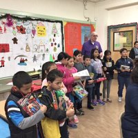 12-15-16 - Christmas with Santa with the help of Los Bomberos Firefighters, Mission Education Center, San Francisco - Students wait patiently as other students receive their gifts from Santa.