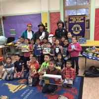 12-15-16 - Christmas with Santa with the help of Los Bomberos Firefighters, Mission Education Center, San Francisco - A class poses with Santa and the Los Bomberos Firefighters.