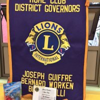 12-15-16 - Christmas with Santa with the help of Los Bomberos Firefighters, Mission Education Center, San Francisco - The Geneva-Excelsior Lions Club banner with some of the gifts and the Los Bomberos Firefighters certificate of thanks.