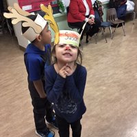 12-15-16 - Christmas with Santa with the help of Los Bomberos Firefighters, Mission Education Center, San Francisco - Susan, excited, waiting to see Santa. Zenaida Lawhon in the background.