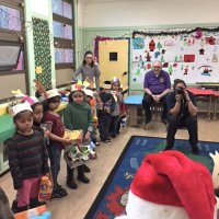 12-15-16 - Christmas with Santa with the help of Los Bomberos Firefighters, Mission Education Center, San Francisco - Students, have received their gifts from Santa, wait for others to see Santa.