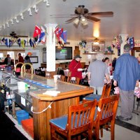 3-5-16 - Mariposa Hunters Point Yacht Club, San Francisco - 31st Annual Crab Feed - The cracked crab just arriving off to the left as others continue to set up tables. L to R: delivery guy, Ward Donnelly, Bob Fenech, Sharon Eberhardt, Jerry Lowe, Zenaida Lawhon, Eddie Marchese, and Stephen Martin.