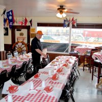 3-5-16 - Mariposa Hunters Point Yacht Club, San Francisco - 31st Annual Crab Feed - Adding rolls to plates is Viela du Pont, and adding the finishing crab bibs is Bob Fenech.