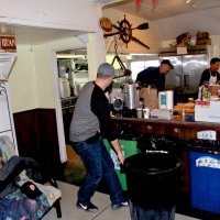 3-5-16 - Mariposa Hunters Point Yacht Club, San Francisco - 31st Annual Crab Feed - Moving cans of crab into the kitchen area to add the marinade. L to R: helper, Stephen Martin, Mike Speciacci, Jr., and Bob Fenech.