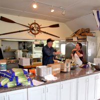 3-5-16 - Mariposa Hunters Point Yacht Club, San Francisco - 31st Annual Crab Feed - Discussing the marinade are Stephen Martin, left, and Mike Spediacci, Jr.; Viala du Pont cleaning up in the background.