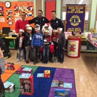 12/21/17 - Christmas with Santa, Mission Educational Center - School children pose with San Francisco Firemen after receiving their gifts from Santa.