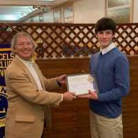 1/16/19 - Club Student Speaker Contest - Lion Paul Corvi presenting a certificate to winner Michael Gray from Riordan High School.