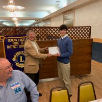 1/16/19 - Club Student Speaker Contest - Lion Paul Corvi presenting a certificate to winner Michael Gray from Riordan High School. Lion President George Salet in the foreground.