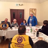 10/17/18 - District Governor's Visitation, Italian American Social Club - L to R outside of table: Lions District Governor Lydia Taylor-Bellinger, President George Salet, Secretary Joe Farrah, 1st Vice District Governor Helen Ariz Casaclang, Cabinet Secretary Denise Kelly, and Sharon Eberhardt. Inside table: visiting Lion Hernaldo Martinez from Pedregal, Panama (in vest.) Lion Cabinet Secretary Denise Kelly talking about District events and the new polo shirts for the District.