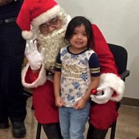 12/18/18 - Los Bomberos Firefighters with Santa at Mission Education Center - Santa posing with a lucky kindergarten student.