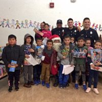 12/18/18 - Los Bomberos Firefighters with Santa at Mission Education Center - Santa, and crew, with the first grade class.