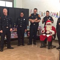 12/18/18 - Los Bomberos Firefighters with Santa at Mission Education Center - Santa eagerly awaiting another class to visit.