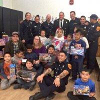 12/18/18 - Los Bomberos Firefighters with Santa at Mission Education Center - Santa, with teachers and crew, with the fourth grade class.