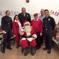 12/18/18 - Los Bomberos Firefighters with Santa at Mission Education Center - Santa, some of his crew, and helping Lions Zenaida Lawhon, Bob Lawhon, and President George Salet.