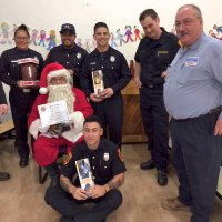 12/18/18 - Los Bomberos Firefighters with Santa at Mission Education Center - Some of Santa’s crew, with Lion President George Salet after presentation of a Certificate of Appreciation for their help.