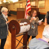 4/18/18 - 2018 Y & C Drawing, IASC - Lion Viela du Pont, raffle chairman, reads another winner as guest Arline Thomas, and Lions Lyle Workman and Bob Fenech look on.