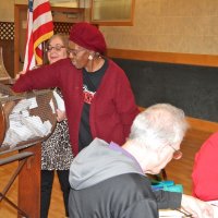 4/18/18 - 2018 Y & C Drawing, IASC - Guest Mildred Hamilton, with Eastern Star, Rho Chapter, drawing another winner as Lion Viela du Pont, raffle chair, looks on. Lion Lyle Workman tracking winners, as Lion Sharon Eberhardt reads a brochure from Lion Helen Casaclang running for 1st VDG.