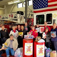 12/15/19 - Facebook - Lion Steve Martin, center, in back, in front of exhaust vent hose, helping with the Annual Toys for Tots Drive at SFFD Station 2. Toys collected by Cathay Post 384 of the American Legion.