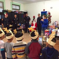 12/13/19 - Mission Education Center Christmas with Santa and Los Bomberos Firefighters - members of Los Bomberos, Santa, and Principal Deborah Molof enjoying the children’s singing.