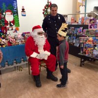 12/13/19 - Mission Education Center Christmas with Santa and Los Bomberos Firefighters - one of the 200 students talking with Santa just before receiving his gift from Santa.