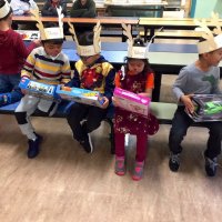 12/13/19 - Mission Education Center Christmas with Santa and Los Bomberos Firefighters - a few of the 200 students comparing their gifts from Santa.