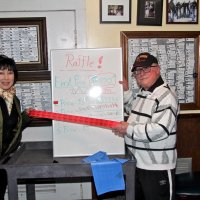 2/23/19 - 34th Annual Crab Feed - Guest Susie Moy with Lion Bob Lawhon, both of whom sold the raffle tickets, displaying the few tickets left and the winning numbers.