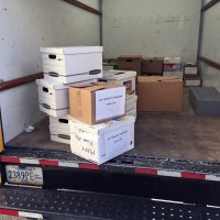 3/27/21 - District 4-C4 Annual Eyeglass Collection, Daly City - The step-van where boxes of used eye glasses were stacked after weighing. Boxes from several clubs are seen; the Geneva-Excelsior Lions’ boxes are stacked three high containing 571 pairs weighing about 33 lbs.