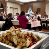 2/8/20 - 35th Annual Crab Feed at St. Philip the Apostle Church - by Roxanne Gentile - Crab in the tray ready to be eaten; part of the Clews/Jones group in the background.