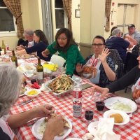 2/8/20 - 35th Annual Crab Feed at St. Philip the Apostle Church - by Lion Bob Lawhon - Rosalinda Corvi (in green sweater), wife of Lion Paul Corvi, delivering another tray of crab to the Clews/Jones and Toohey table.
